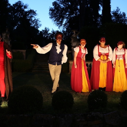 Outdoor performance in Florence with four students acting in traditional Commedia masks.